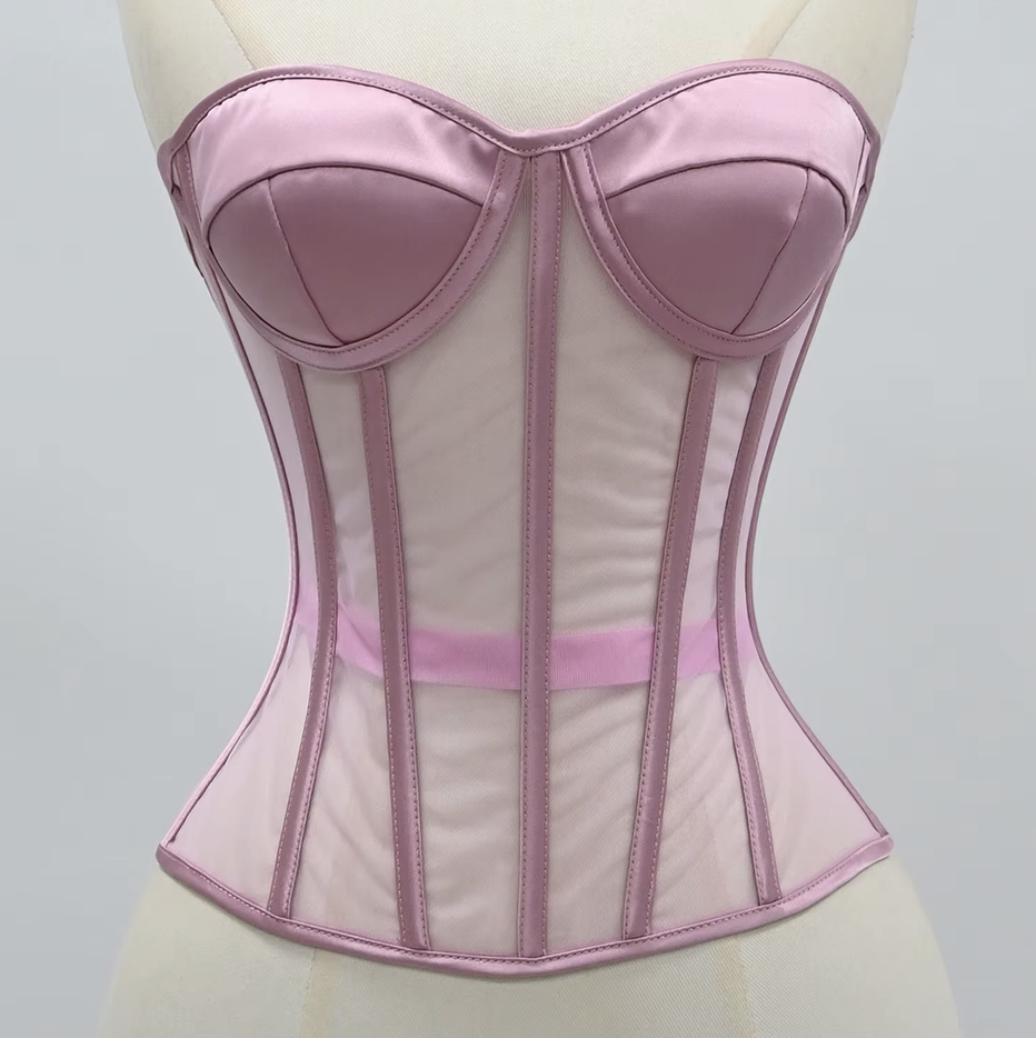 The Lilah pink satin and mesh corset bustier displayed on a cream-colored dress form mannequin against a neutral light gray background.
