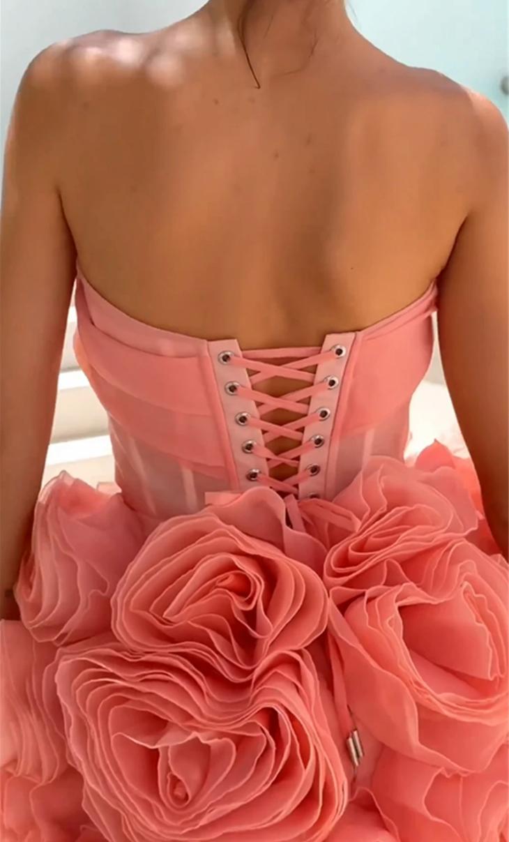 Pink strapless corset mini dress featuring a lace-up back and voluminous 3D organza flower detailing.