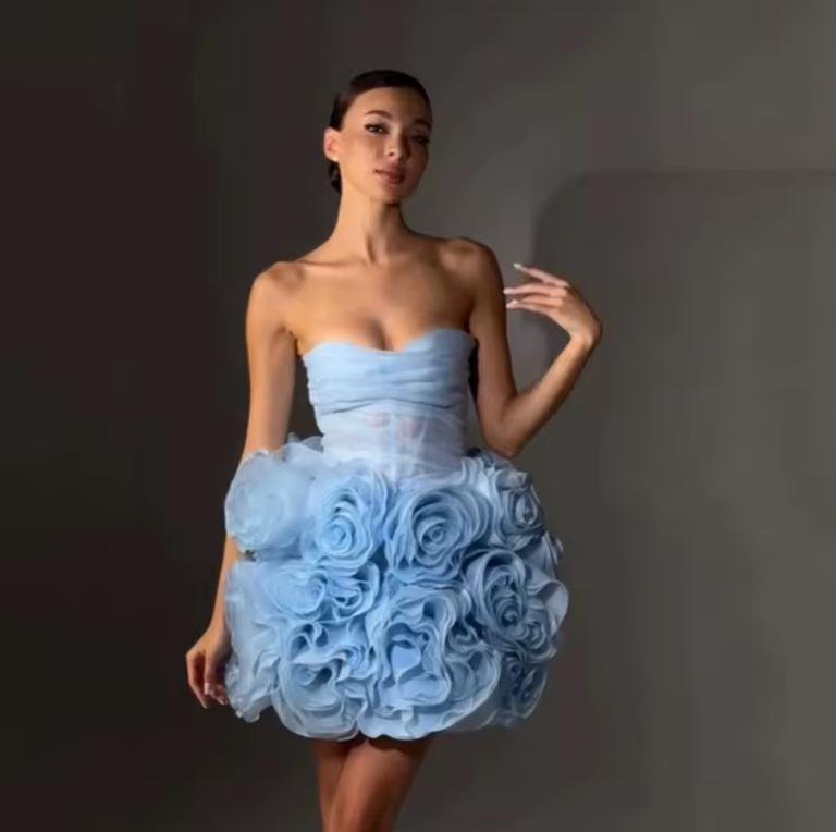 Light blue strapless corset mini dress featuring 3D organza flower embellishments and a structured tulle skirt.