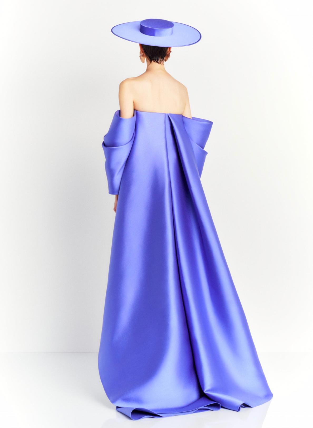 Strapless purple satin evening gown with a dramatic court train and matching wide-brimmed hat.
