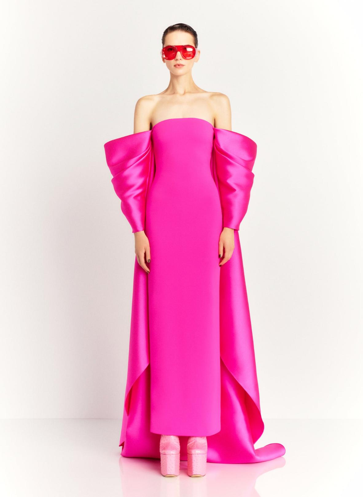 Hot pink strapless satin evening gown with dramatic puffed sleeves and a long court train.