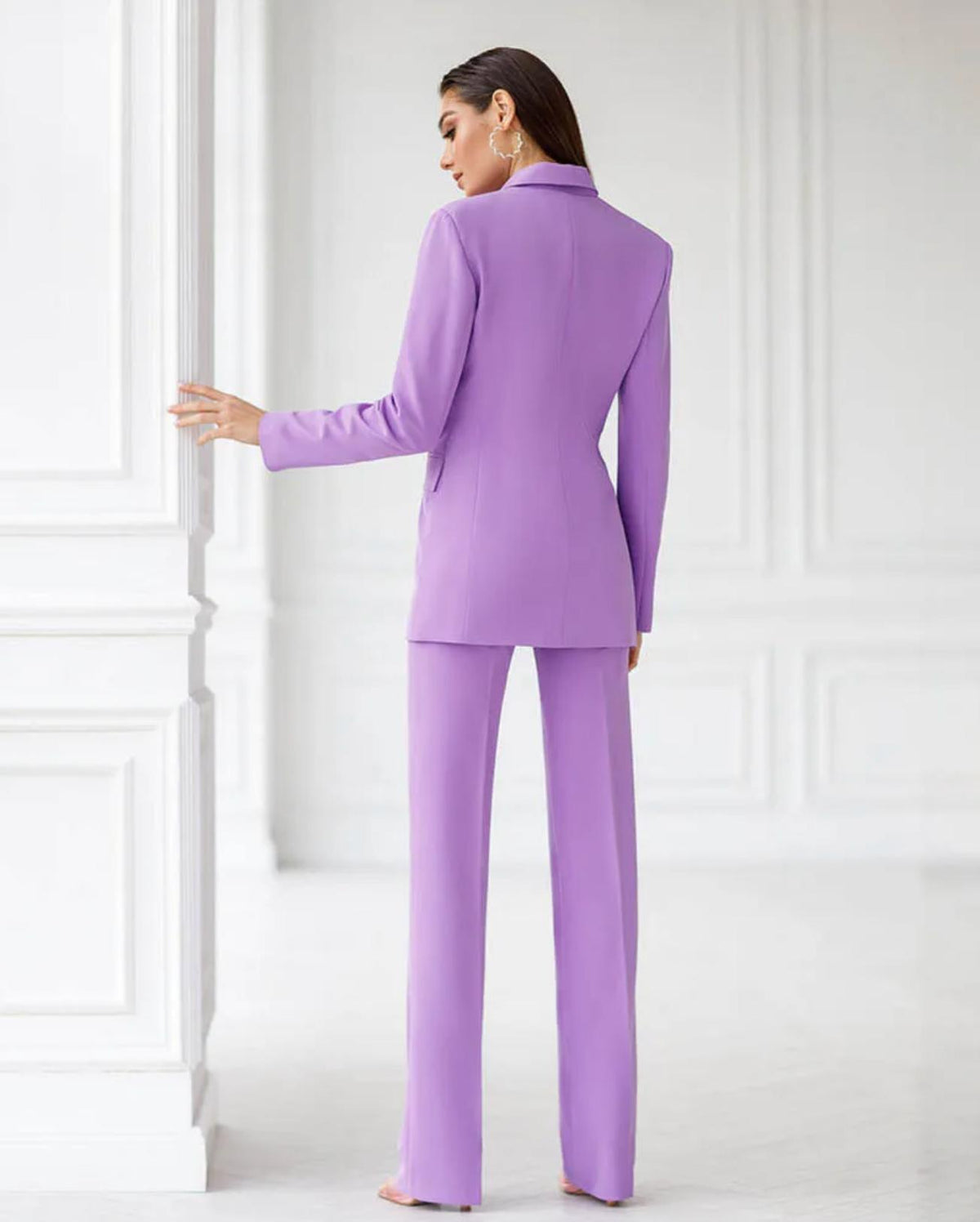 Woman wearing a sleek, lavender single-breasted three-piece suit in smooth serge fabric against a white background.
