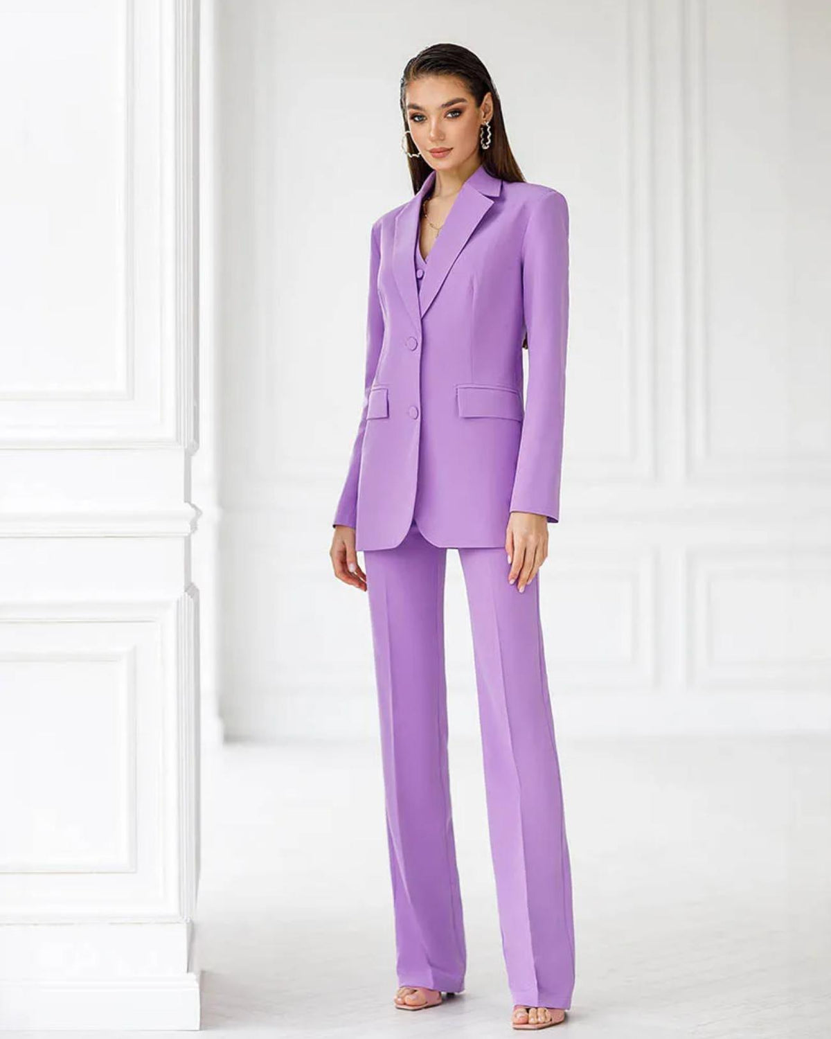Model wearing a lavender three-piece serge suit featuring a single-breasted blazer, vest, and tailored trousers.
