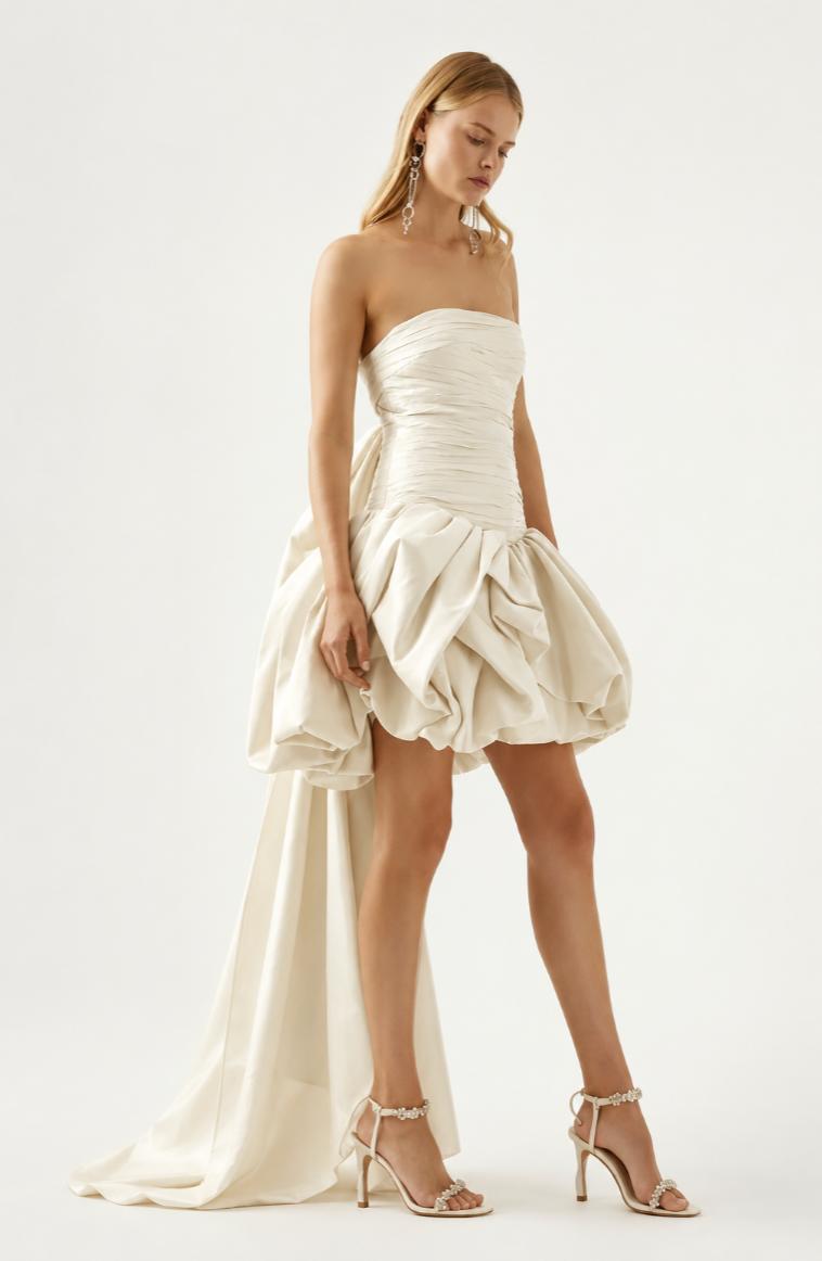 Strapless ivory taffeta mini dress with a ruched bodice, voluminous bubble hem, and an oversized back bow.