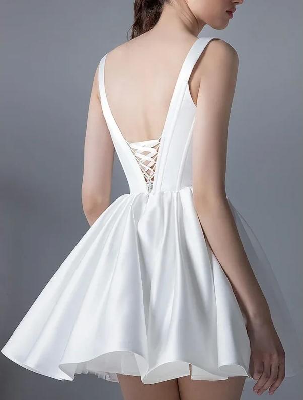 White satin mini dress with a sleeveless bodice, flared skirt, and a lace-up corset back detail.
