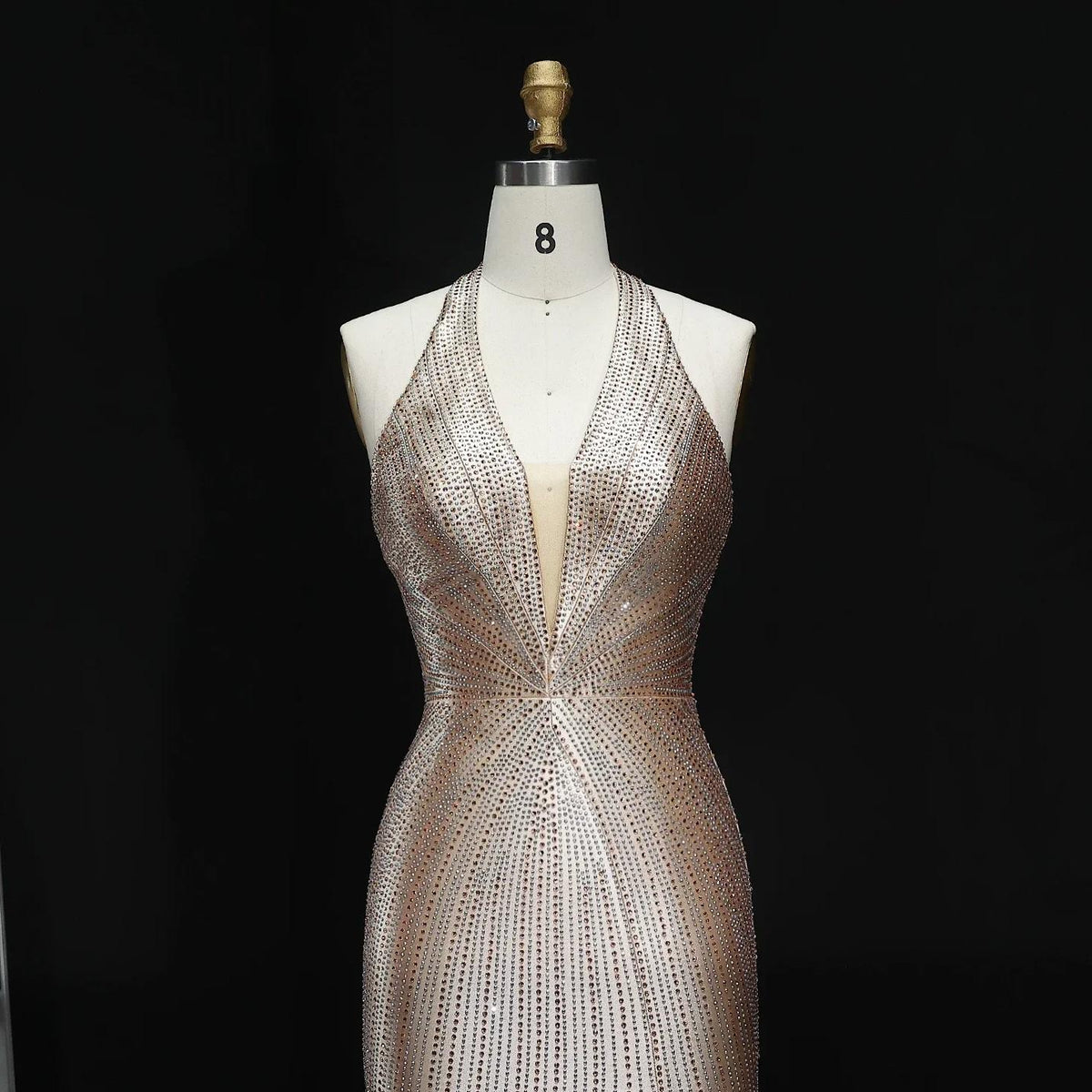 Midnight Soiree satin evening gown with a plunging halter neckline and intricate crystal embellishments on a mannequin.