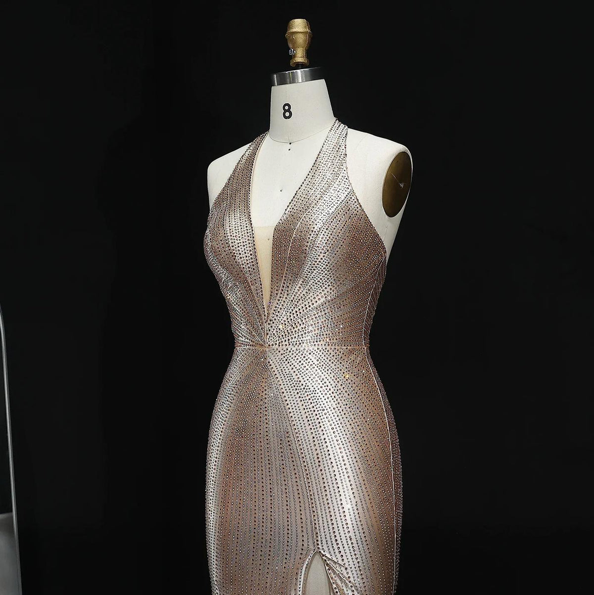 Midnight Soiree satin evening gown with crystal appliqués, halter neckline, and thigh-high slit on a mannequin.