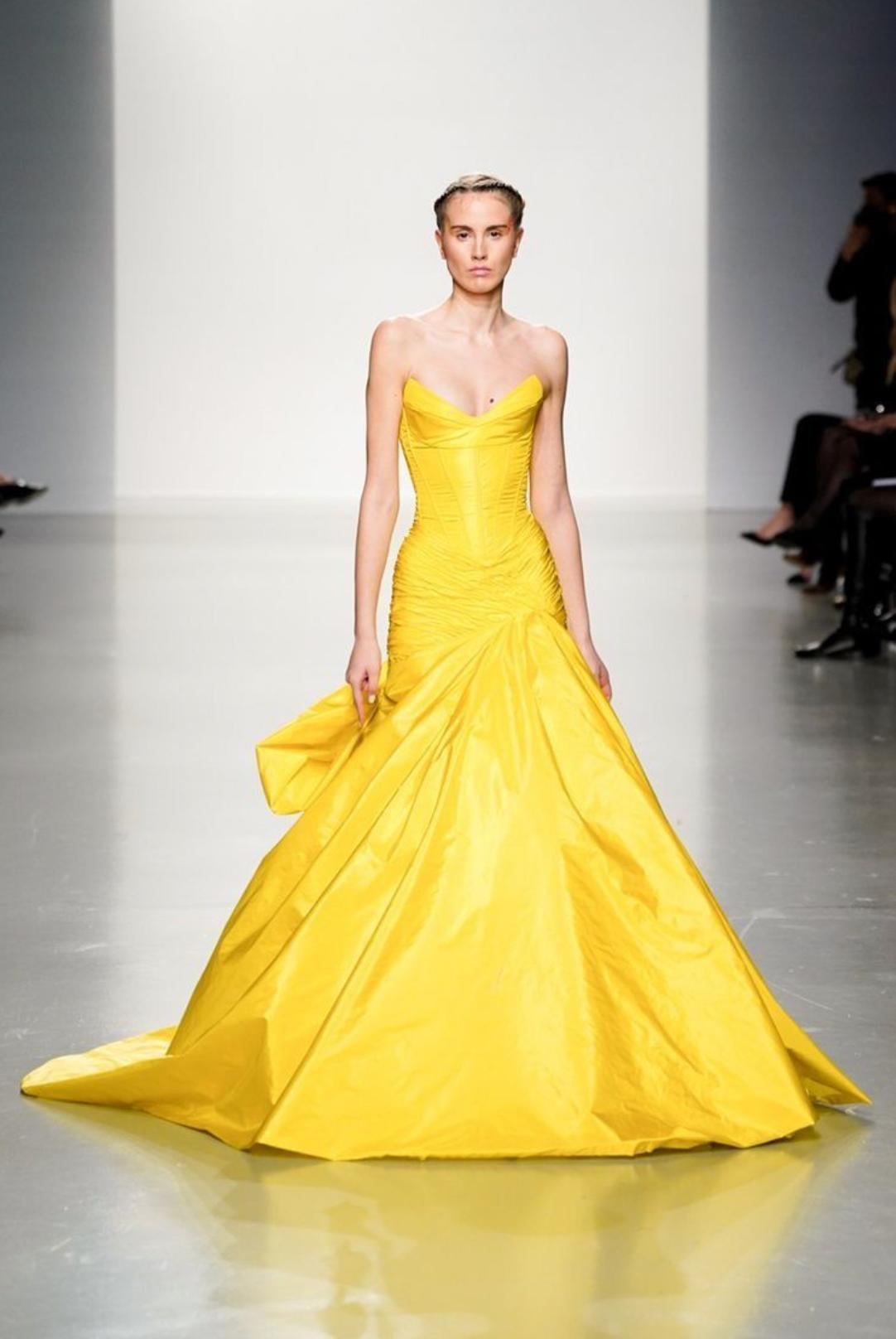 Bright yellow sleeveless taffeta gown with a sweetheart neckline, pleated bodice, and dramatic floor-length sweep train.