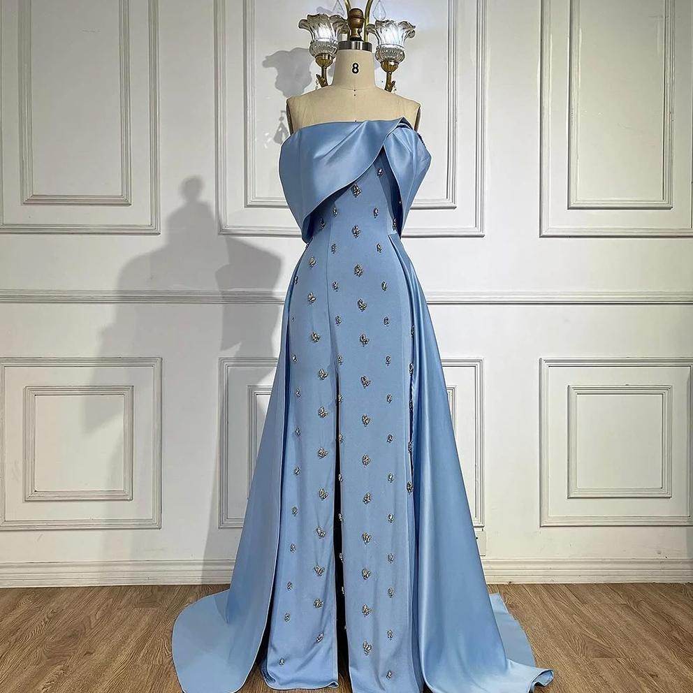 Light blue satin off-shoulder gown with a beaded overskirt and A-line silhouette on a mannequin.