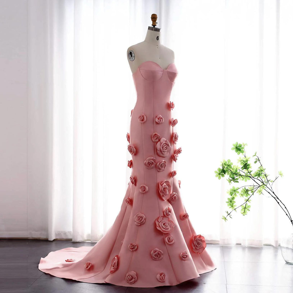 Pink satin mermaid gown with sweetheart neckline and 3D floral appliqués on a floor-length trumpet silhouette.