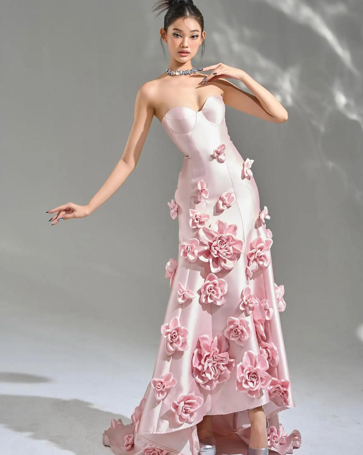 Sleeveless pink satin mermaid gown featuring a sweetheart neckline and cascading 3D floral appliqués.