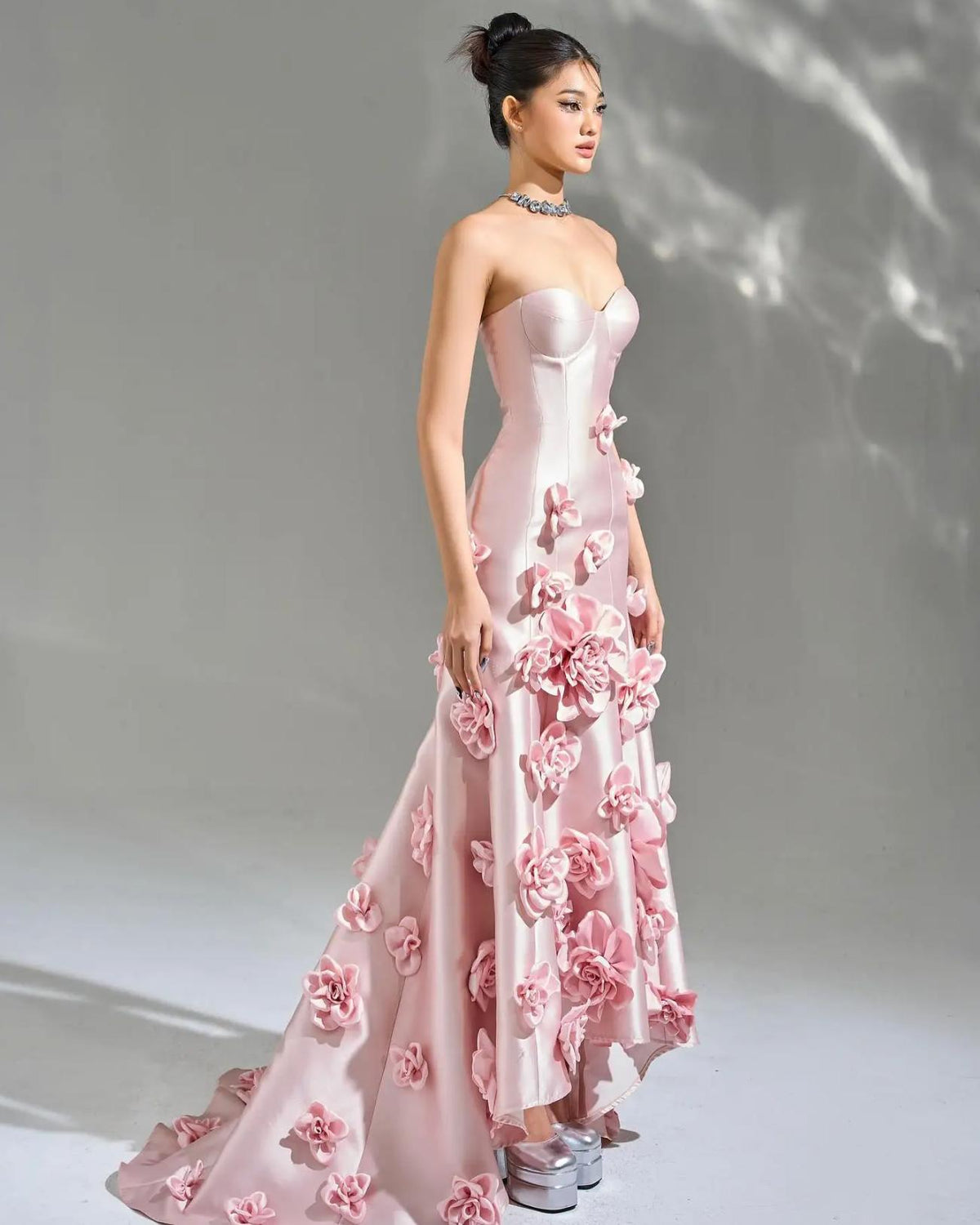 Pink satin mermaid gown with 3D floral appliqués, sweetheart neckline, and floor-length trumpet silhouette.