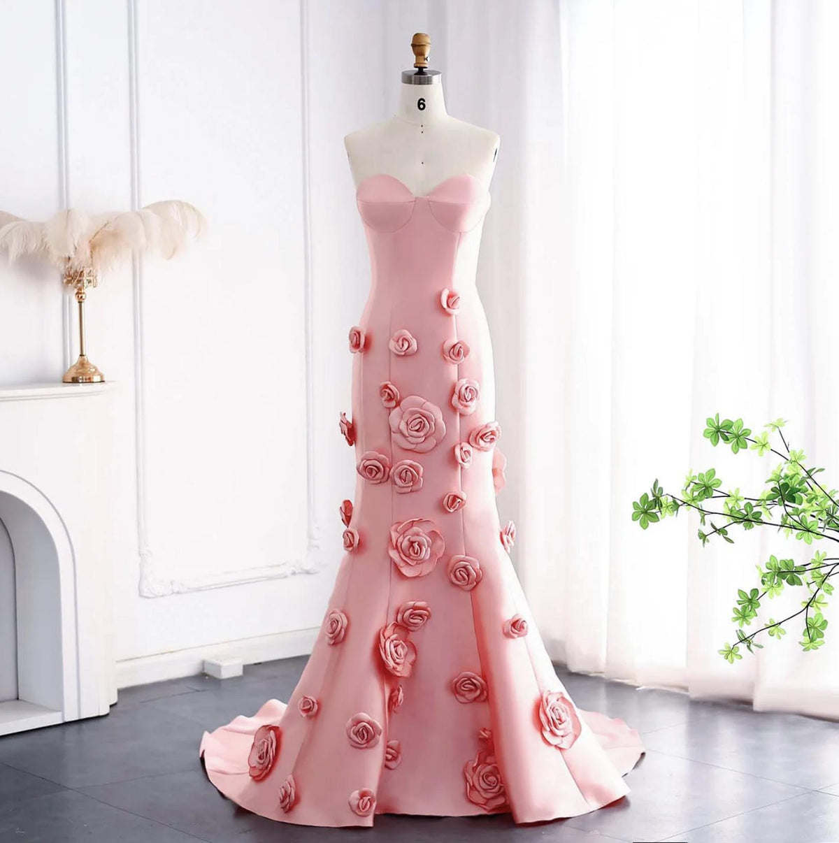 Pink satin mermaid gown with a sweetheart neckline and 3D floral appliqués on a floor-length trumpet silhouette.