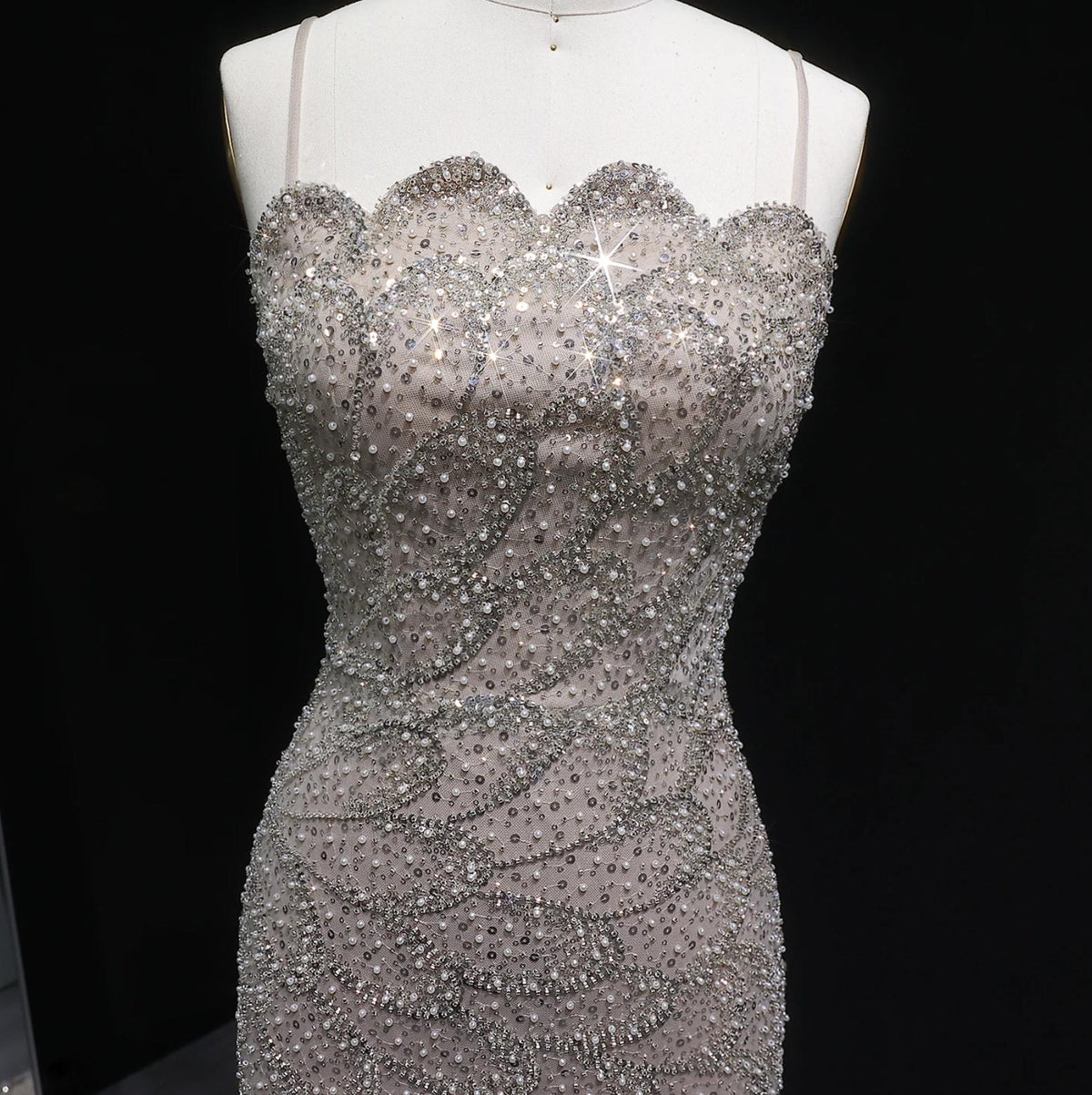 Emerald green mermaid gown featuring intricate silver beading, crystal appliqués, and a scalloped strapless neckline.