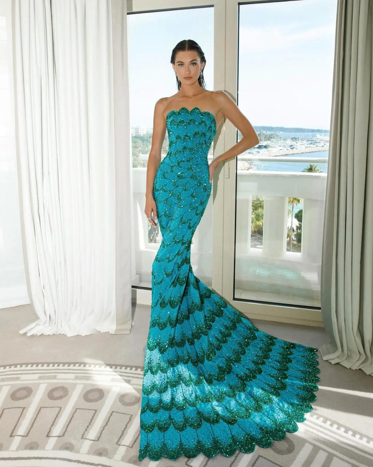 Emerald green strapless mermaid gown with intricate crystal beading and a sweeping tulle train.