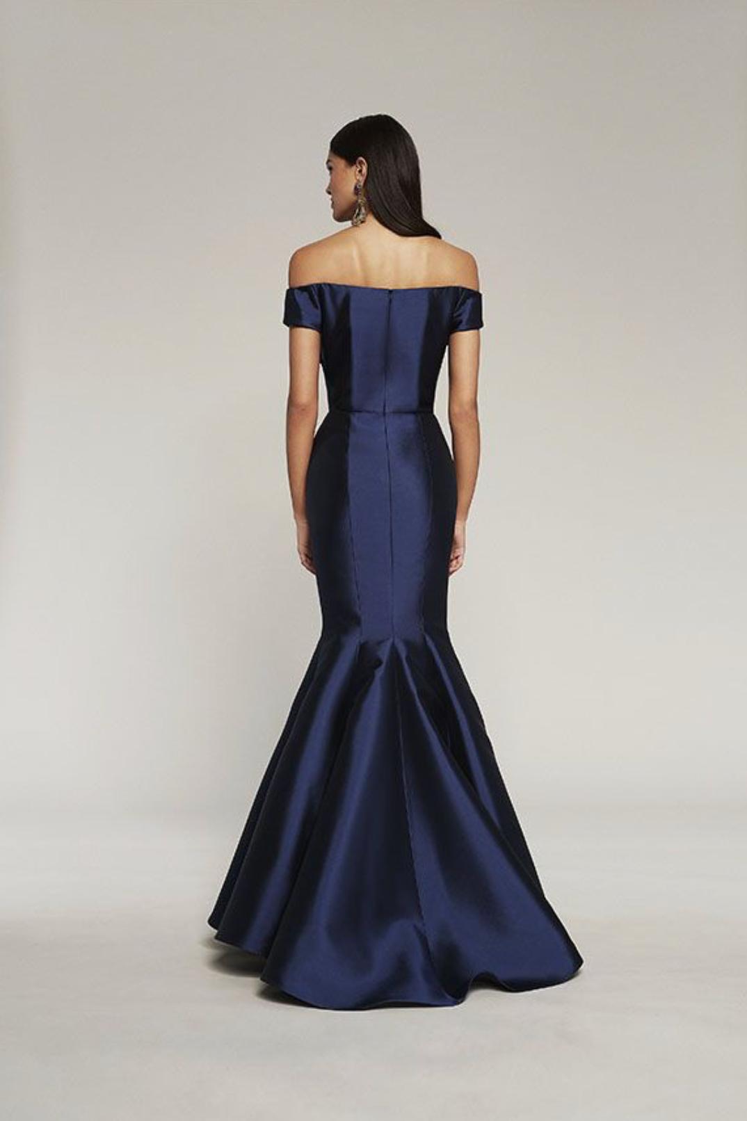 Back view of a navy blue off-the-shoulder satin mermaid gown with a sculpted skirt and elegant draped bodice.