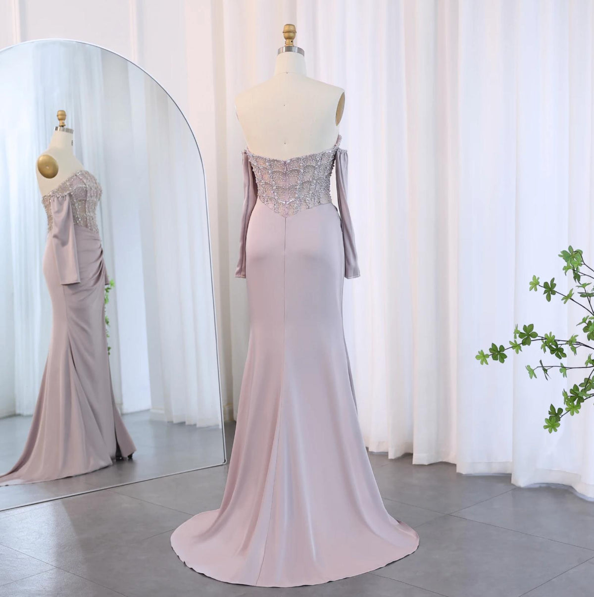 Mauve satin mermaid gown with beaded bodice, off-the-shoulder neckline, and sweep train on a mannequin.