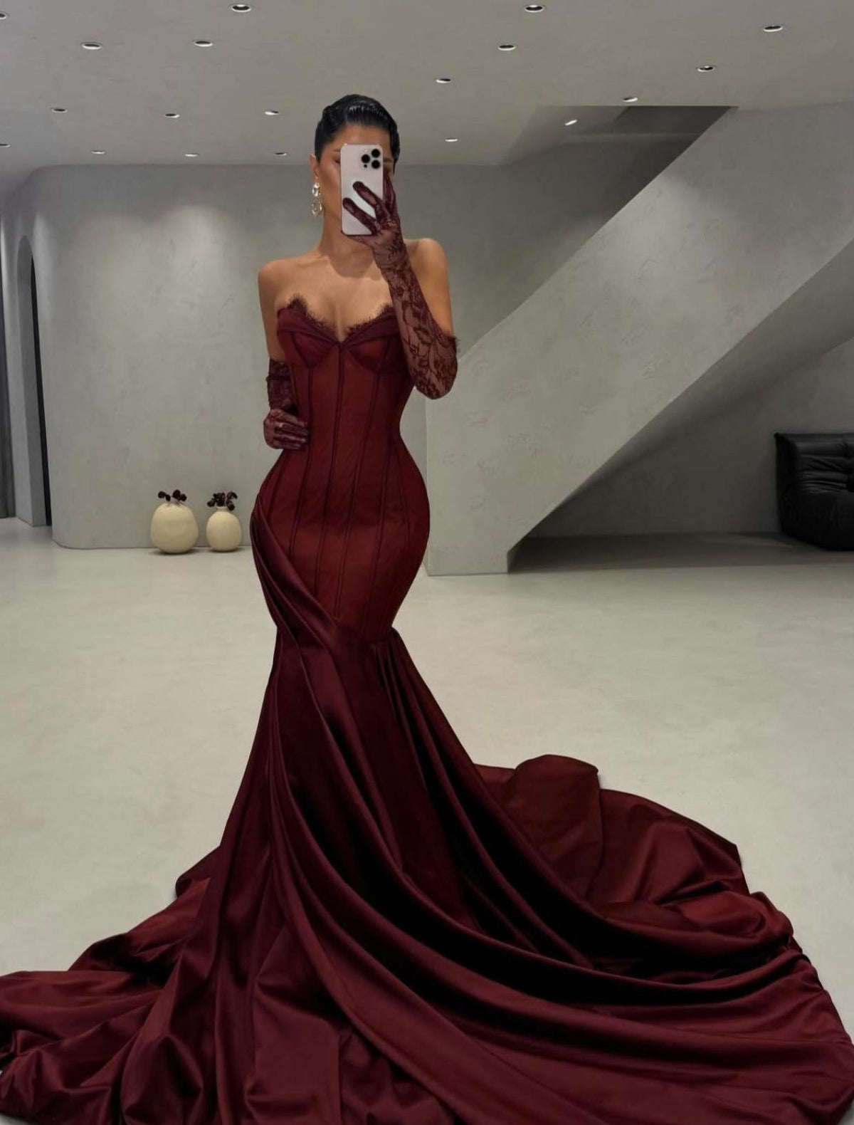 Burgundy satin corset gown with lace sweetheart neckline, side draping, and matching lace gloves with a long train.
