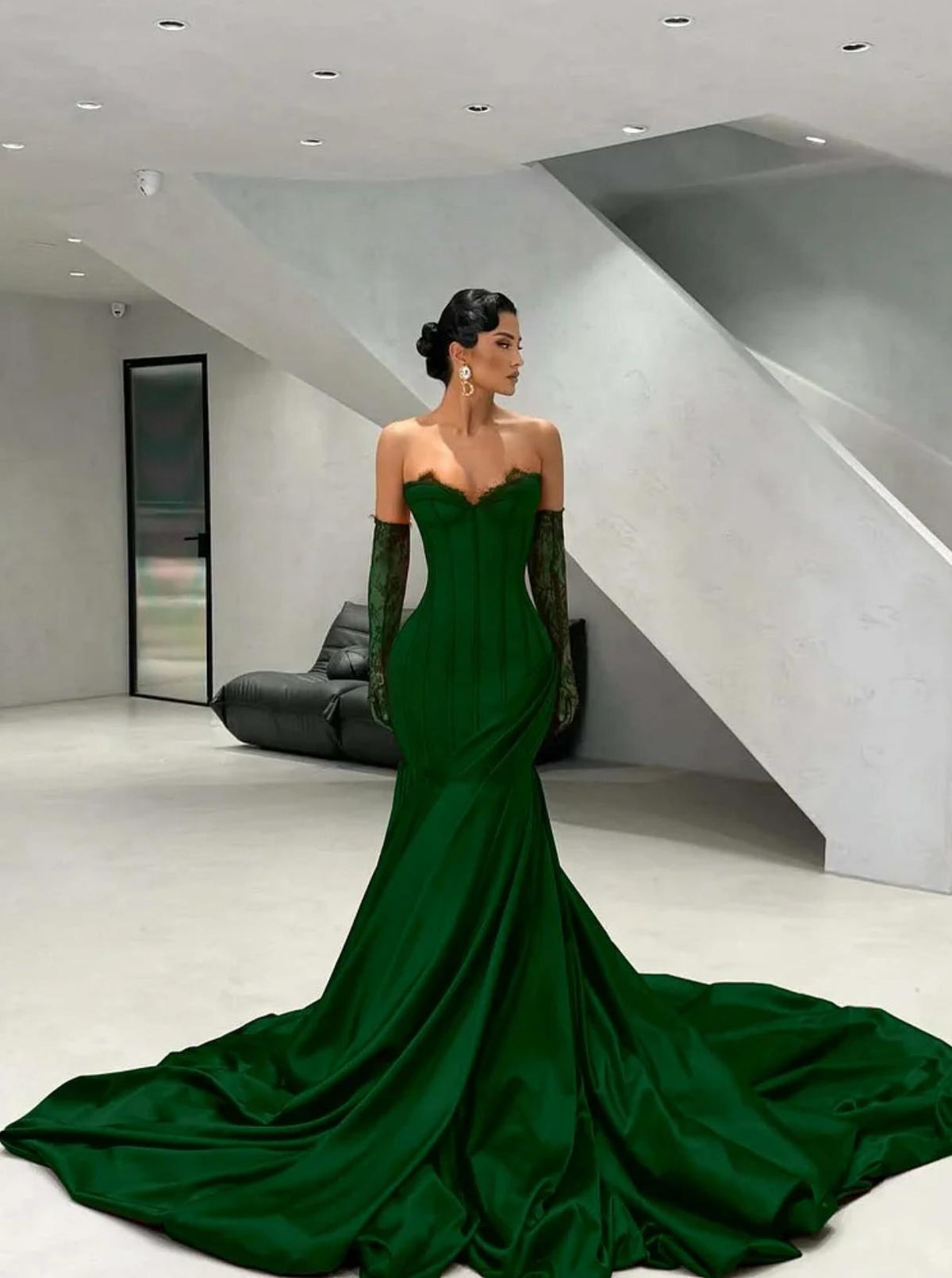 Emerald green satin corset gown with sweetheart neckline, lace detailing, and matching opera-length gloves.