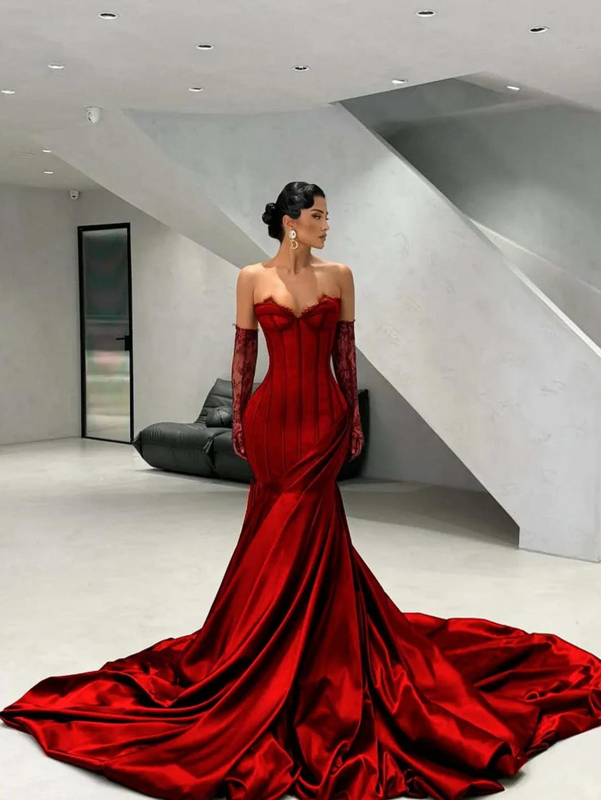 Burgundy satin corset gown with a sweetheart neckline, lace detailing, and matching opera gloves with a long train.