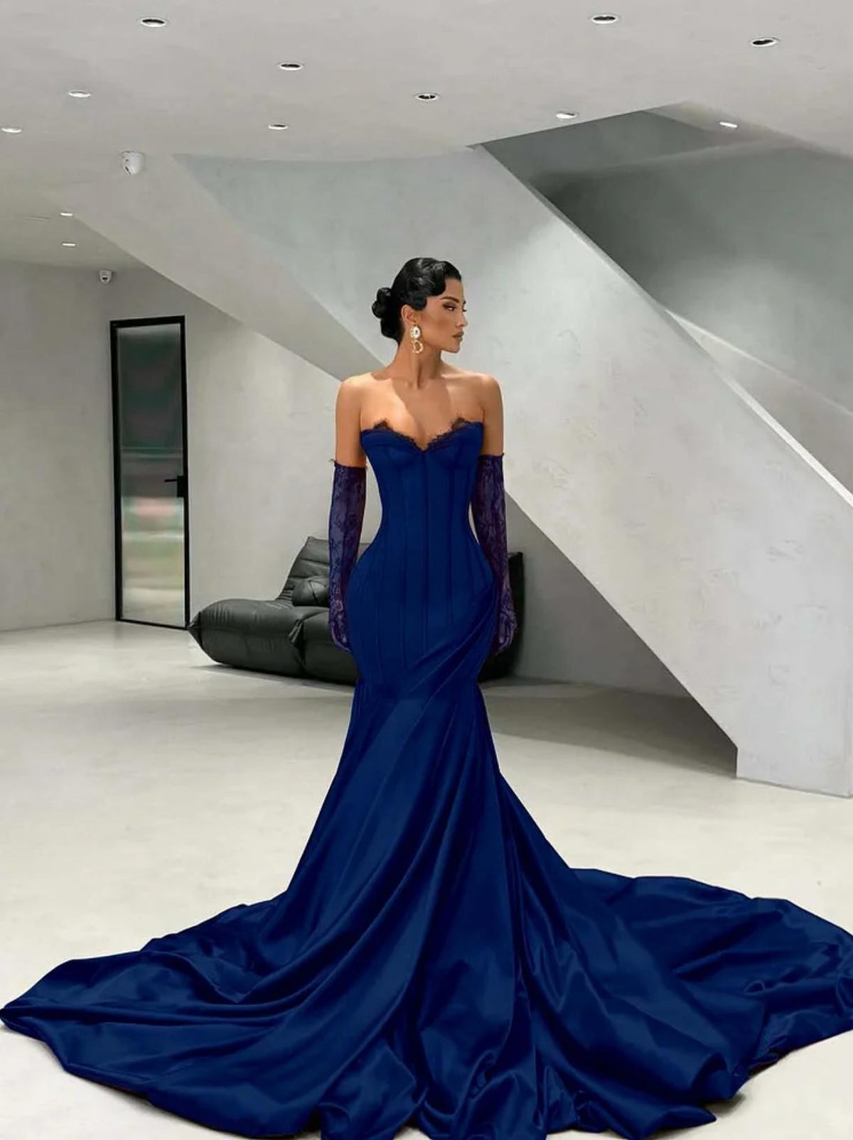 Deep blue satin corset gown with a sweetheart neckline, lace detailing, and matching lace gloves with a long train.
