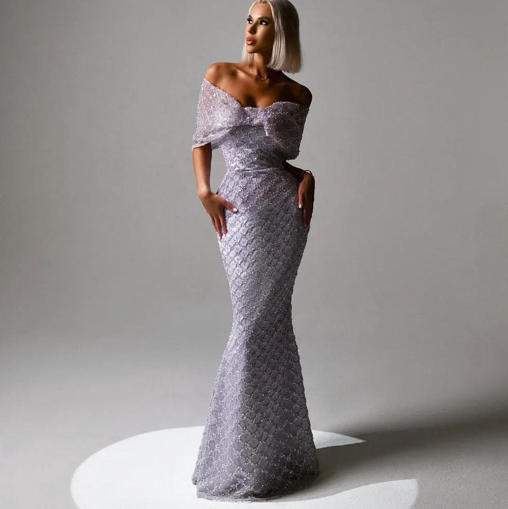 Lavender off-the-shoulder mermaid gown with draped cap sleeves, intricate beaded lace detailing, and a fitted silhouette.