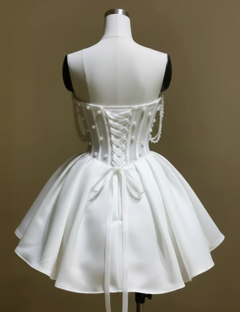 White silk A-line bridal mini dress featuring a lace-up corset back, pearl embellishments, and off-the-shoulder straps.
