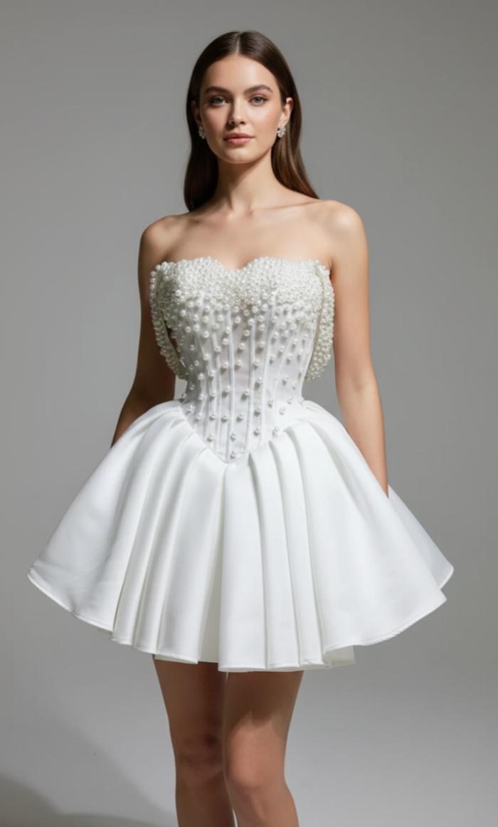 White silk A-line bridal mini dress with an off-the-shoulder neckline and delicate pearl embellishments.