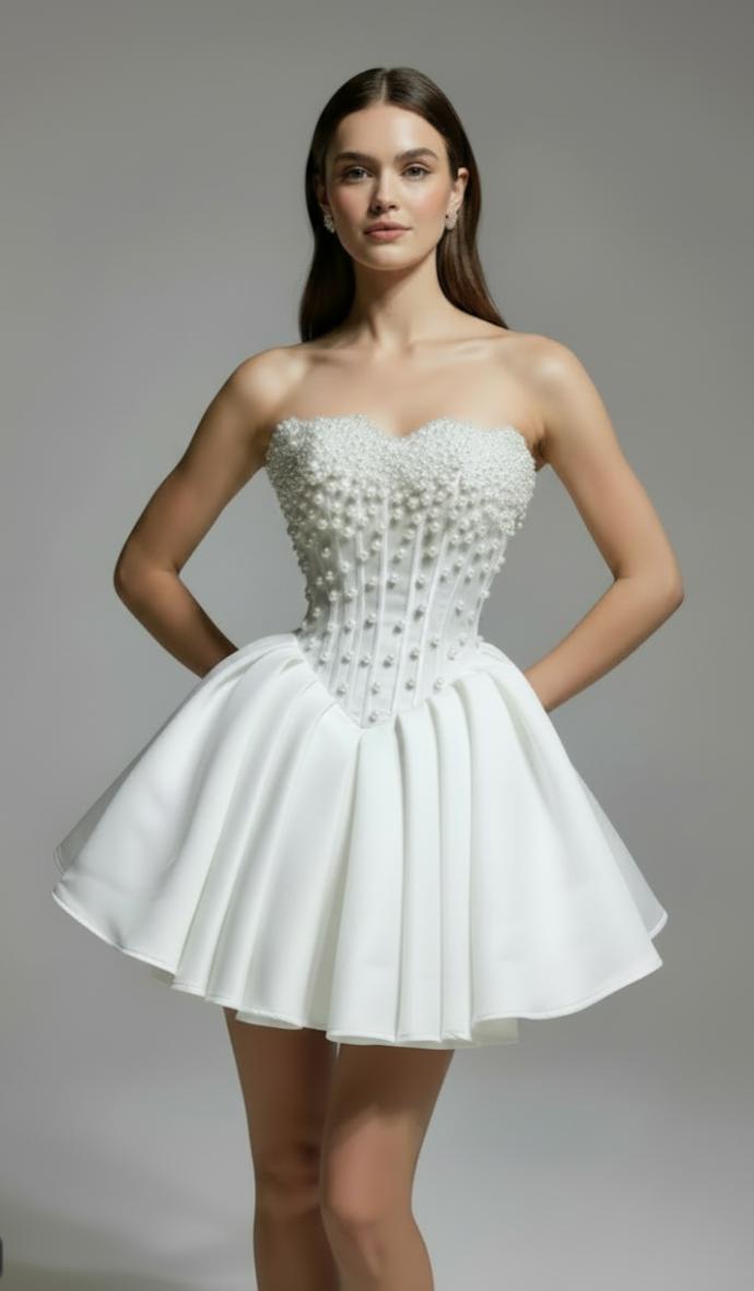 White silk mini bridal dress with a corset bodice, pearl embellishments, and a voluminous A-line skirt.