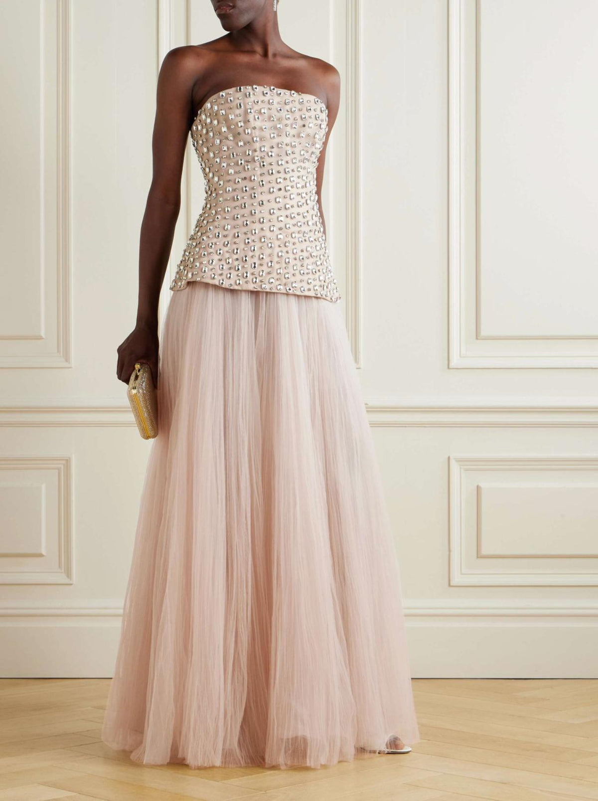 Strapless blush gown with a crystal-embellished bodice and a floor-length pleated tulle A-line skirt.