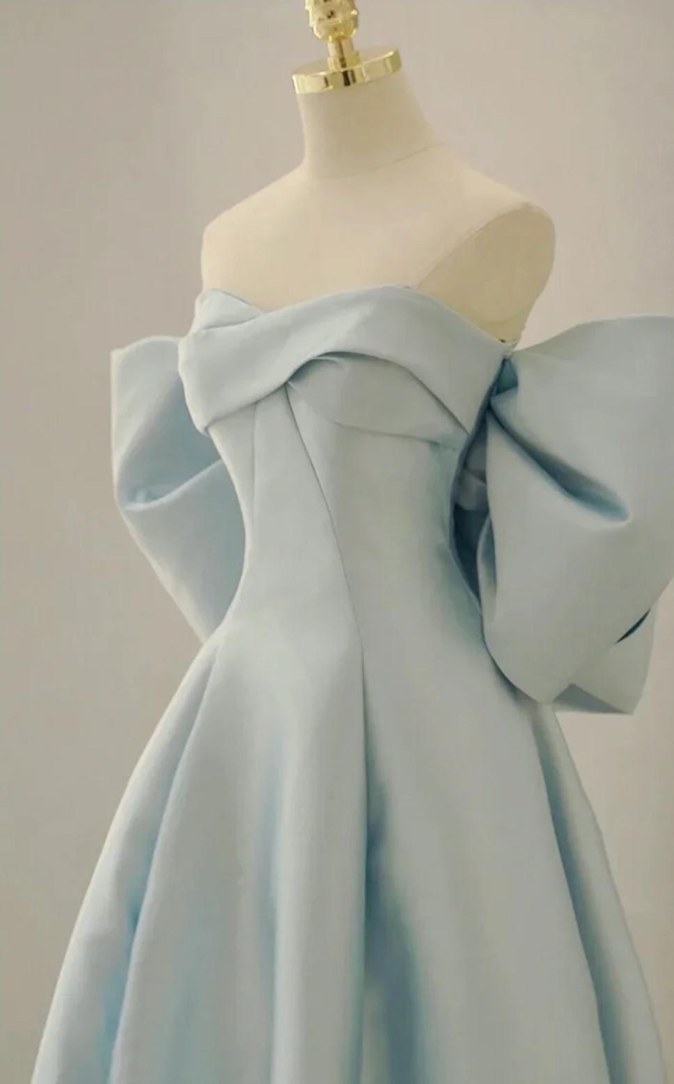 Light blue satin Regina gown with a strapless off-the-shoulder neckline and dramatic bow sleeves on a mannequin.