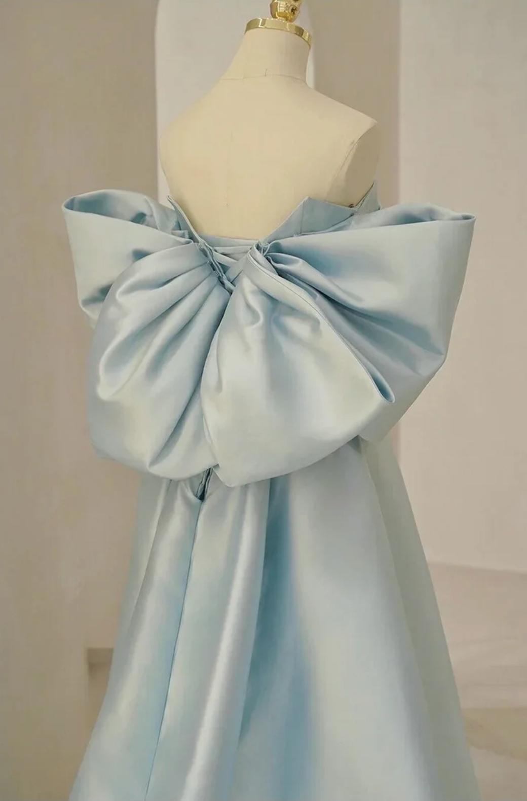 Light blue satin Regina gown featuring a strapless neckline and a large, dramatic bow detail on the back.