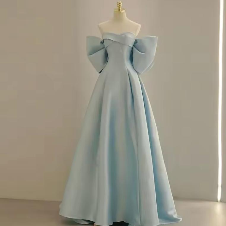 Light blue satin A-line evening gown with a strapless off-the-shoulder neckline and dramatic bow sleeve details.