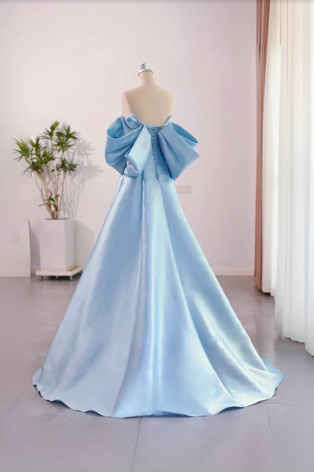 Light blue satin A-line evening gown with a strapless bodice, corset back, and dramatic oversized bow detail.