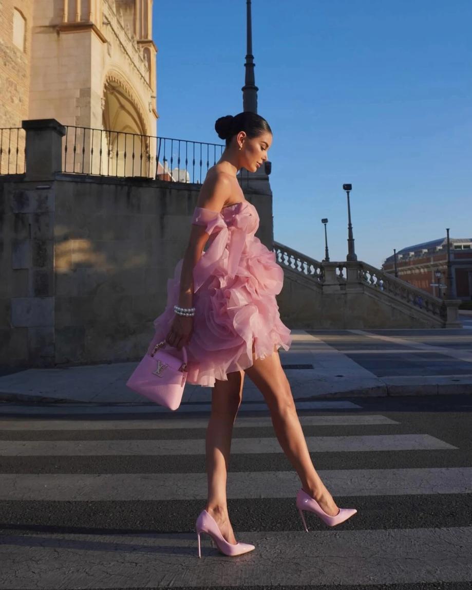 Pink organza mini dress with 3D floral details, sweetheart neckline, and ruched silhouette paired with matching heels.