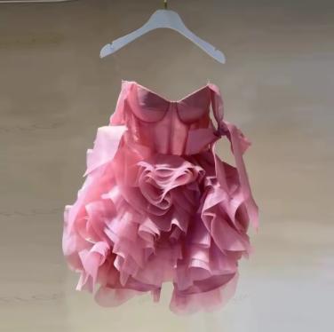 Pink organza mini dress with sweetheart neckline, tie straps, and voluminous ruffled 3D flower details.
