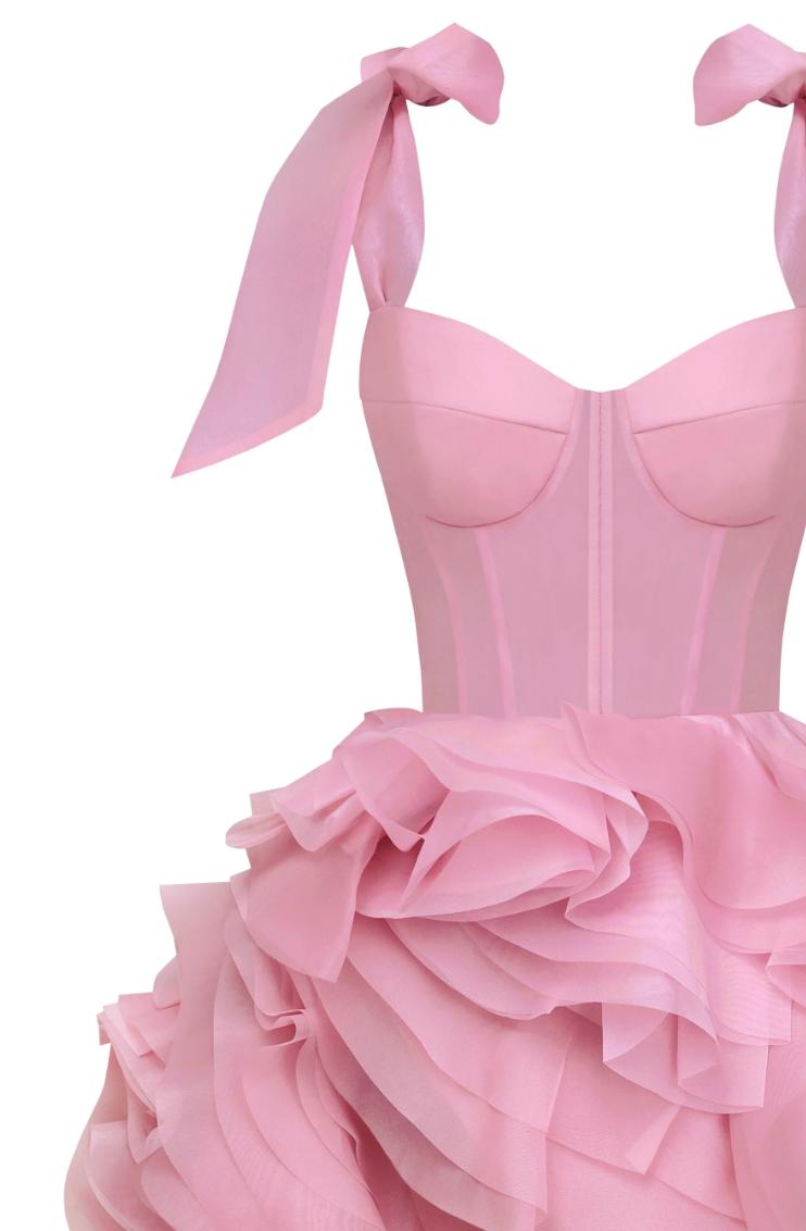 Pink organza mini dress with a sweetheart neckline, tie straps, and voluminous ruffled skirt details.