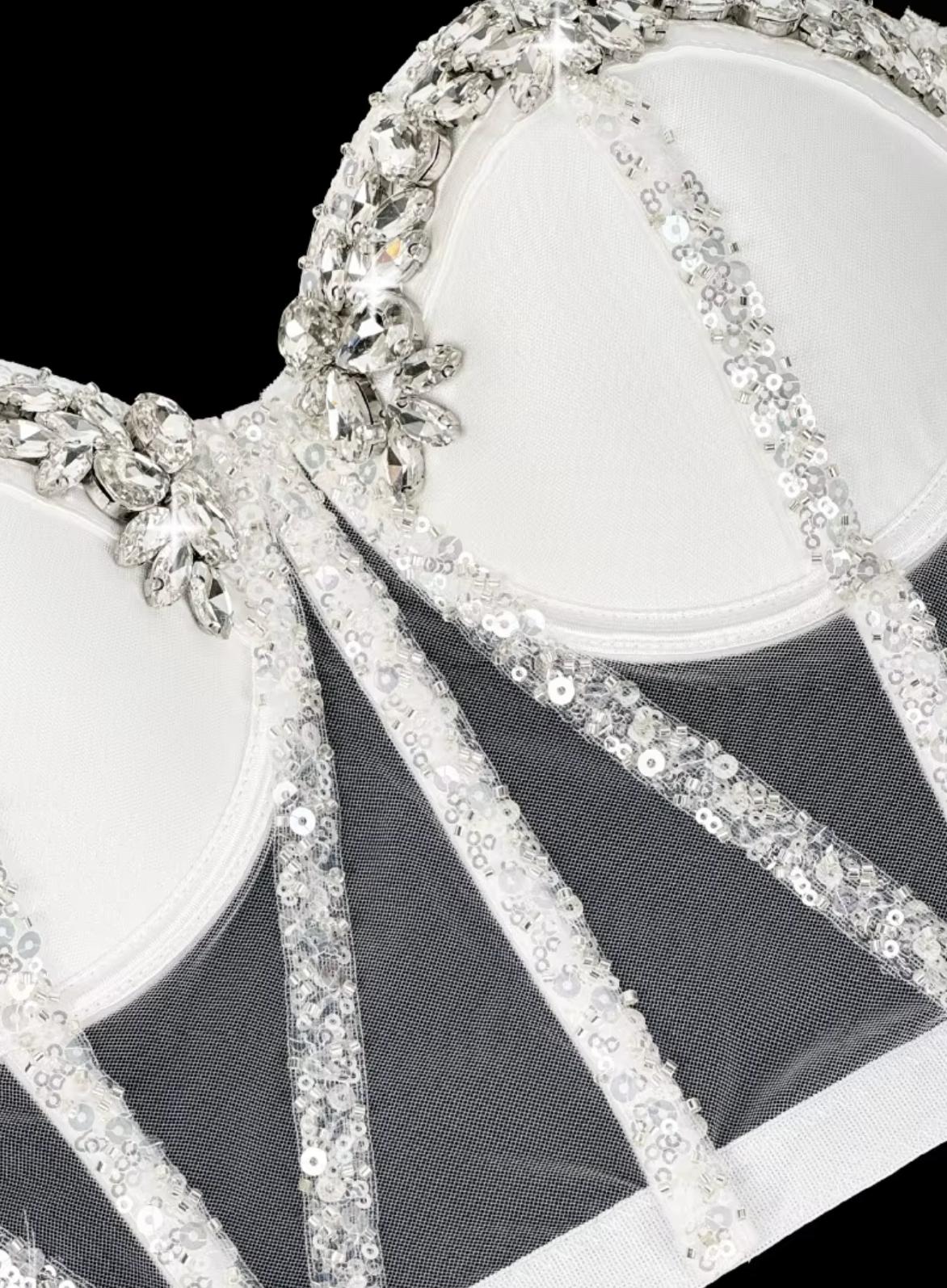 White mesh Rocky bustier featuring structured boning, intricate silver sequin trim, and sparkling crystal rhinestone embellishments.
