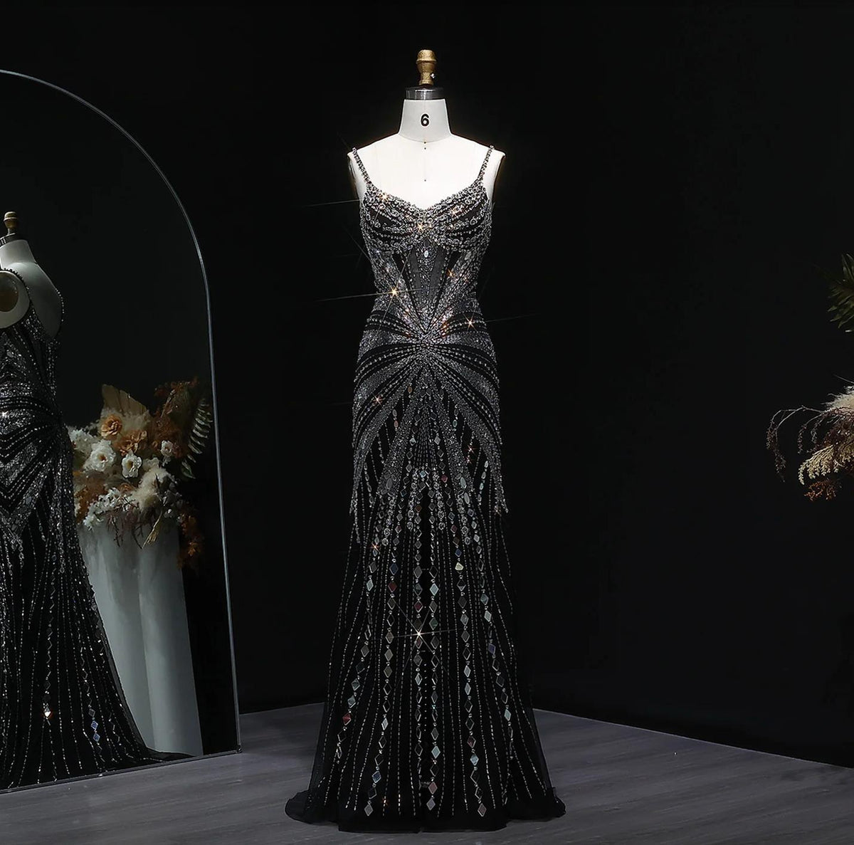 Sade luxury black satin gown featuring intricate crystal beading, spaghetti straps, and a floor-length silhouette.