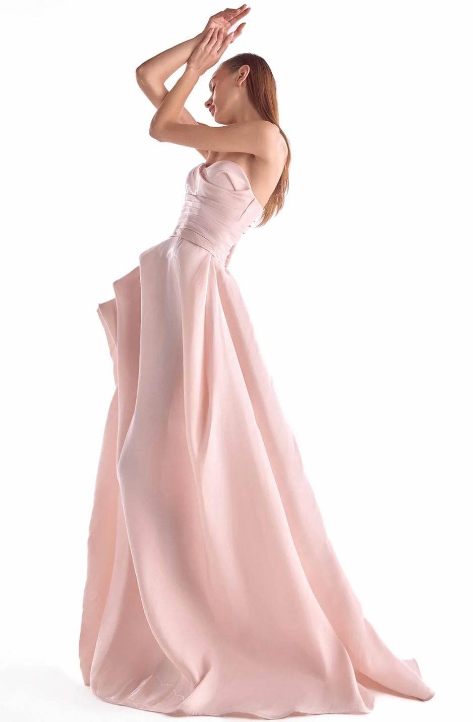 Salmon pink strapless organza gown with a draped bodice, full layered skirt, and a high slit.
