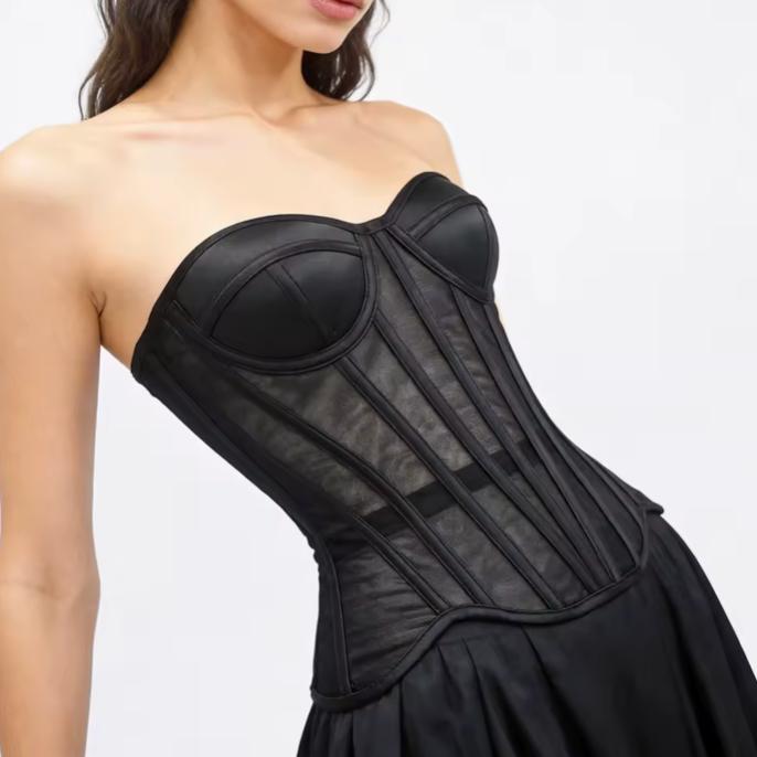 Black waist-cinching corset with sculpted cups, steel boning, and sheer mesh tubing for a structured, elegant silhouette.
