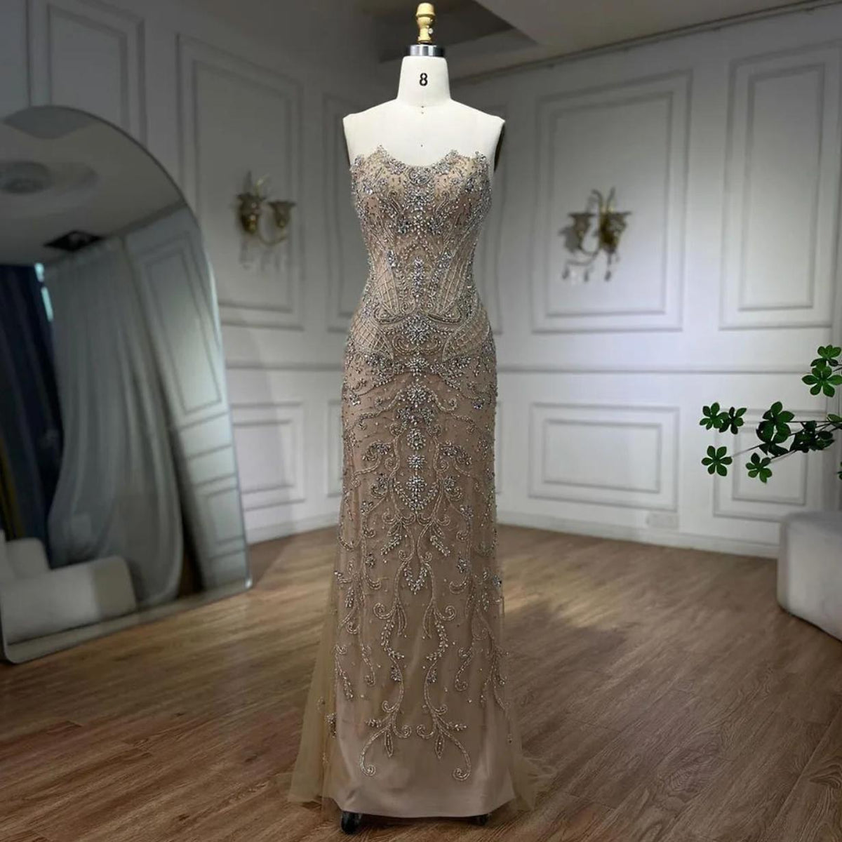 Sleeveless mermaid gown in nude with heavy silver beading, intricate crystal embroidery, and shimmering sequin details.