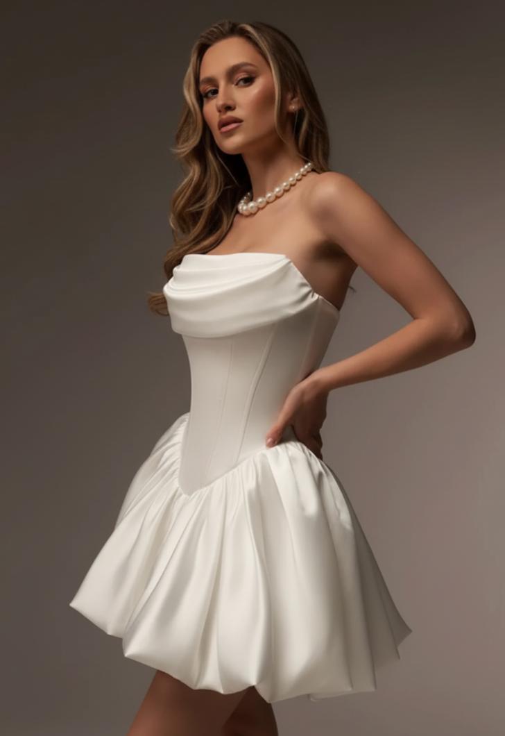 Strapless champagne silk satin A-line mini dress with a structured bodice and draped neckline.