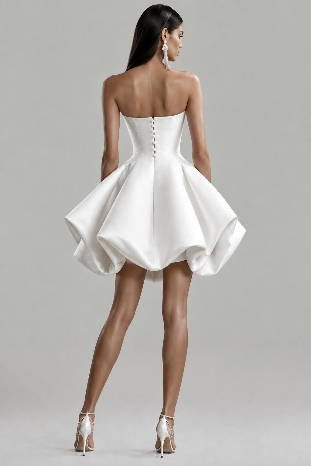 Back view of a white satin bridal gown featuring a strapless sweetheart neckline, button-back closure, and a voluminous bubble skirt.