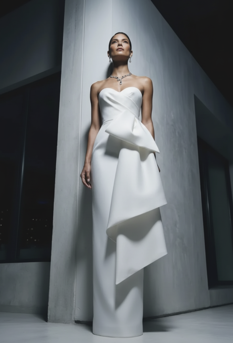 Strapless white Mikado satin gown with a pleated crossover corset bodice and elegant draped side detail.