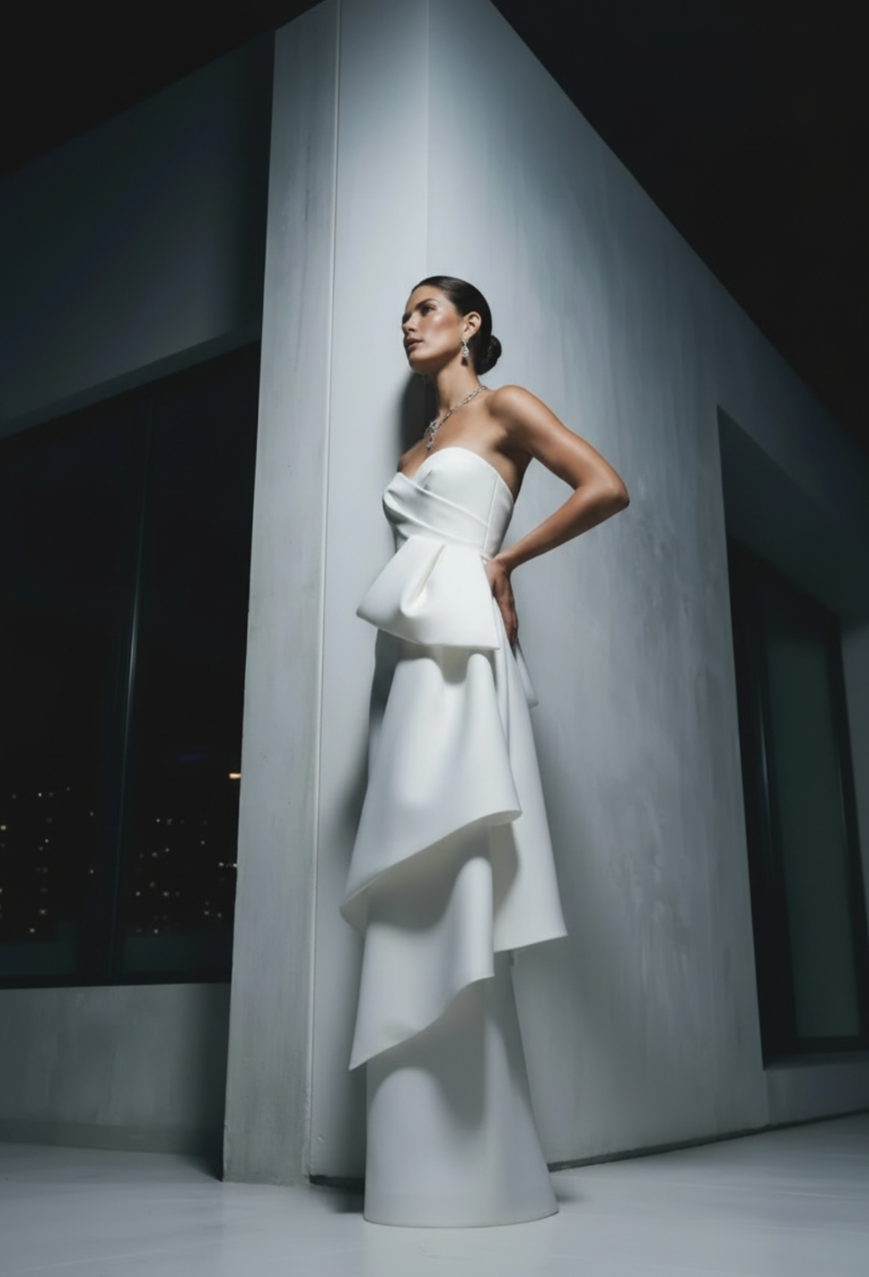 Strapless white Mikado satin gown with a pleated crossover corset bodice and elegant architectural draping.