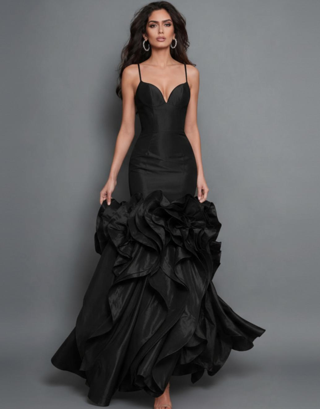 Black couture gown with a structured bodice, fitted waist, and voluminous skirt featuring tiered sculptural flounces.