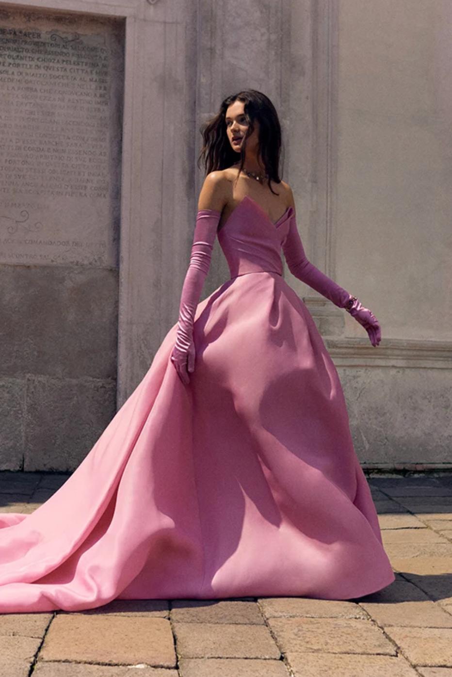 Pink silk gazar and satin cathedral train gown with a sculpted bodice and matching opera-length gloves.