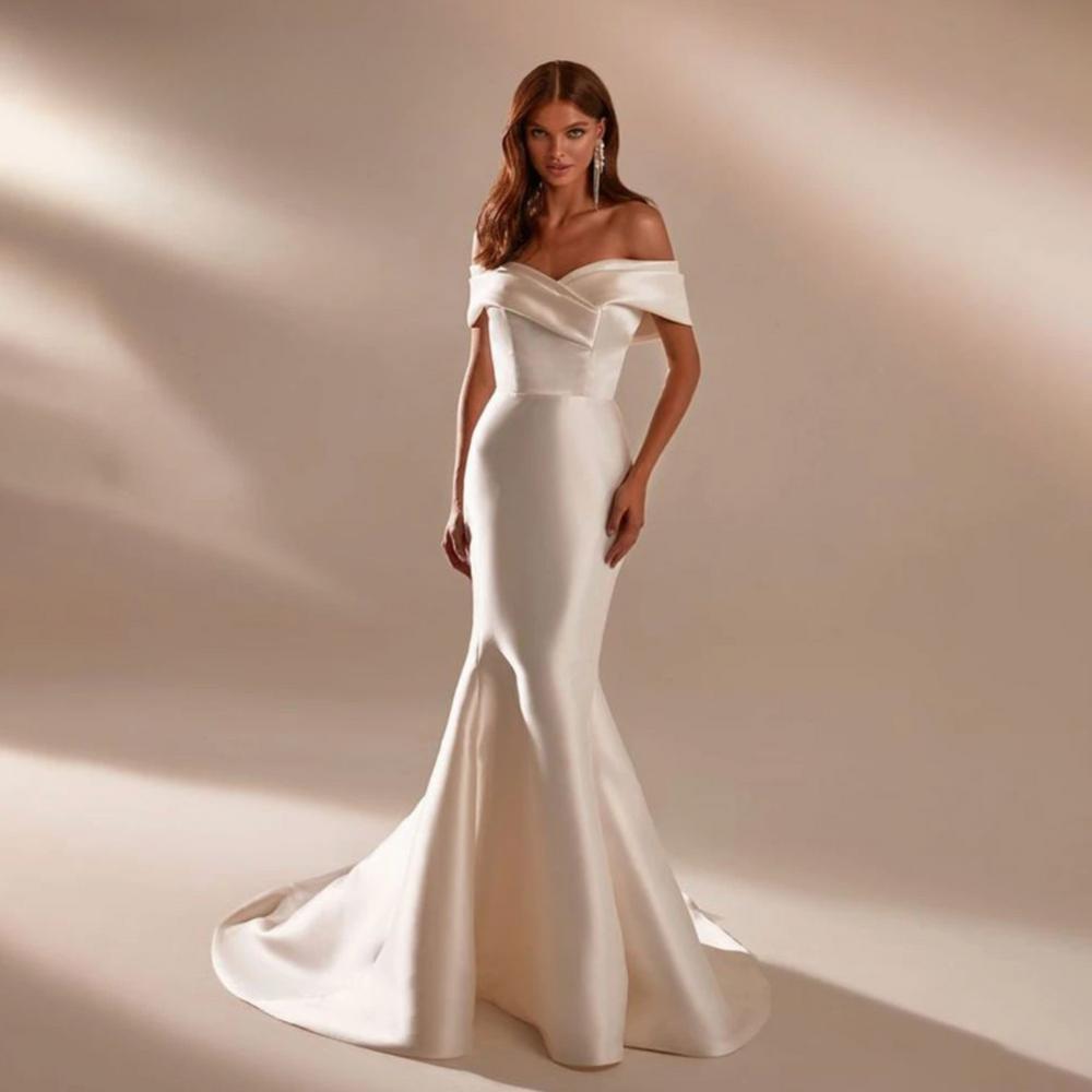 Elegant white satin mermaid wedding gown with an off-the-shoulder neckline and a flowing court train.