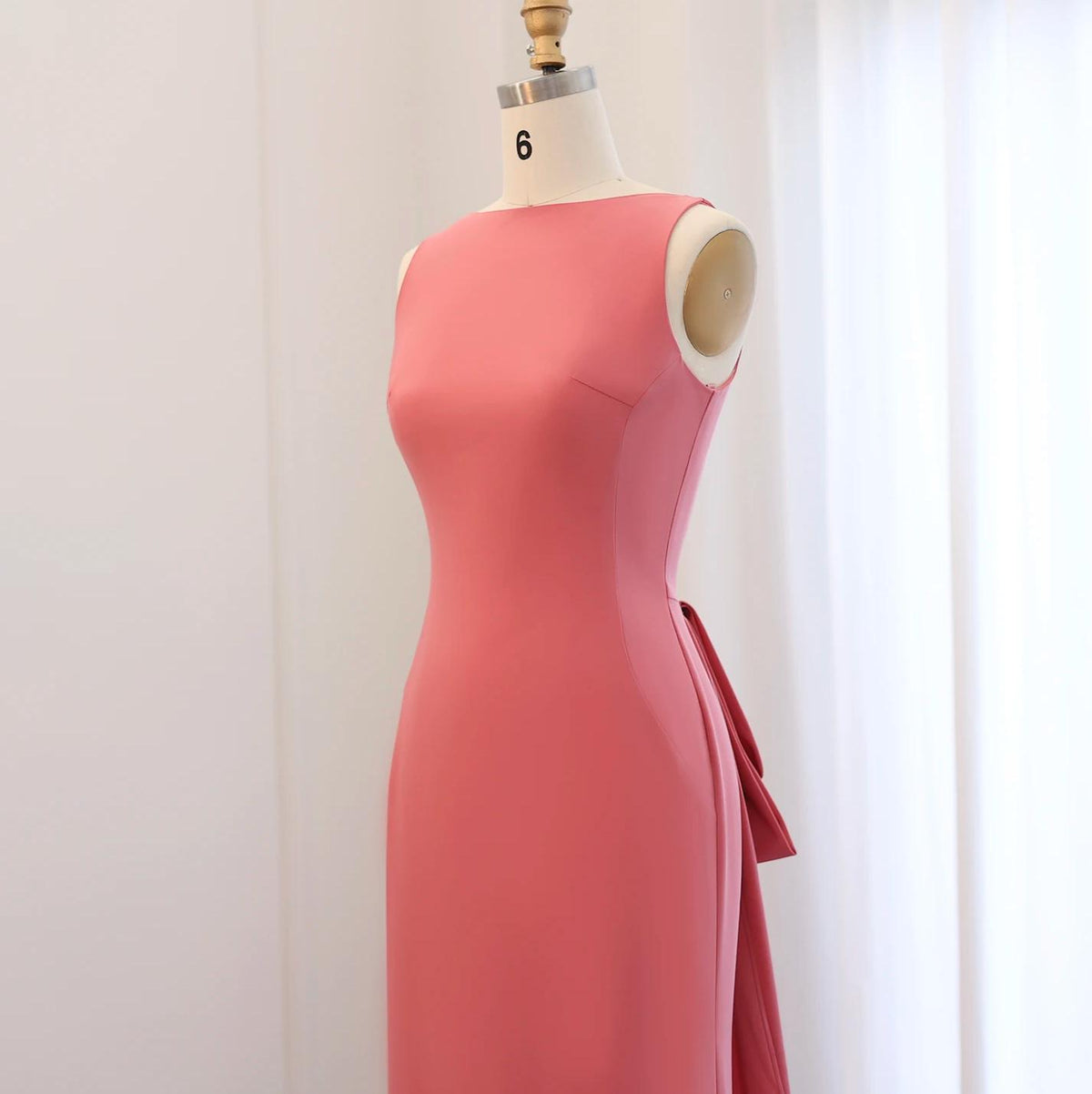Sleeveless pink jersey evening gown on a size 6 dress form, featuring a sleek silhouette and elegant back detail.